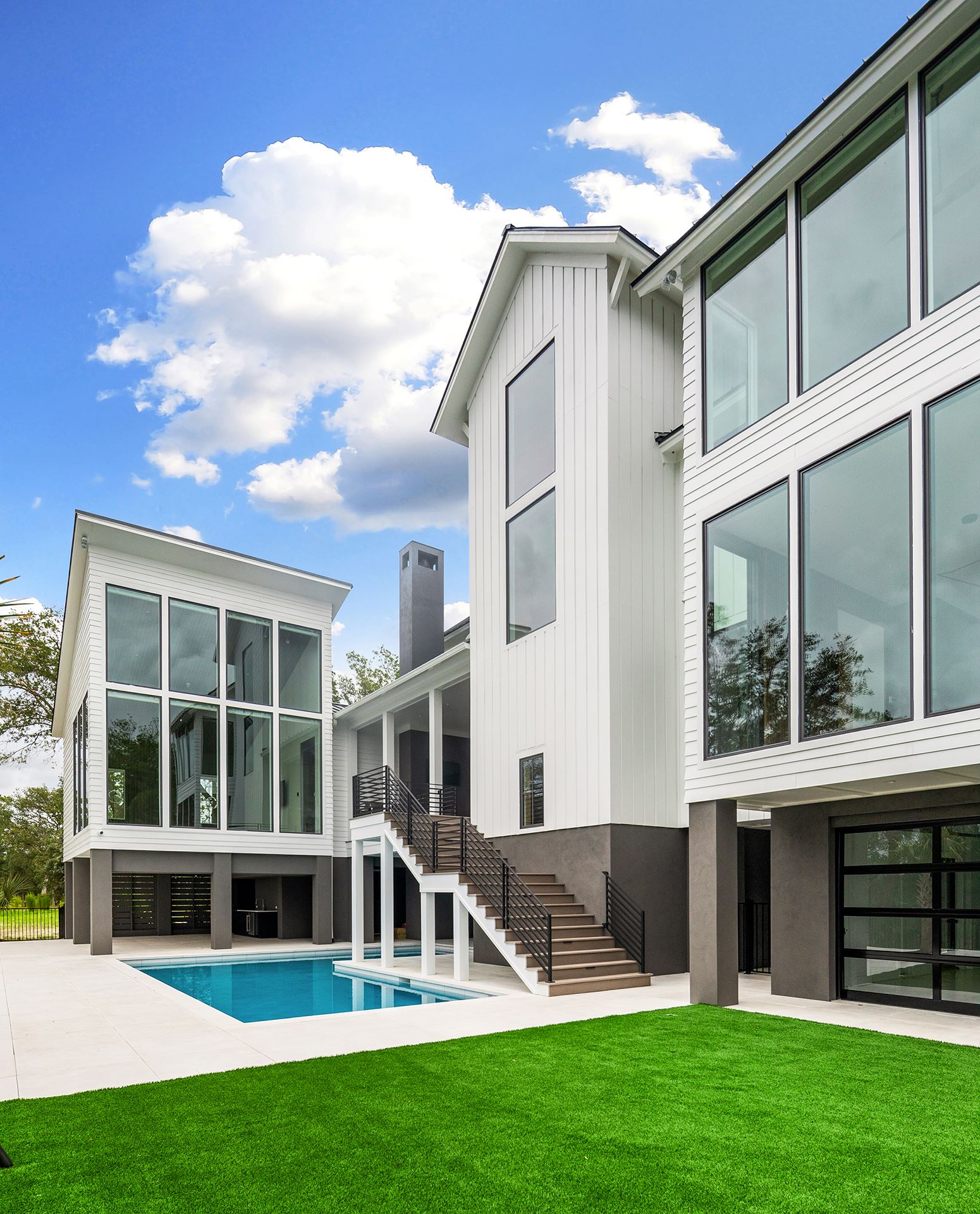 Rear view of custom home with Savannah Smooth in white and pool